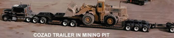 Cozad 2 x 3 x 1 booster moving Cat 988 Loader in a mining pit operation